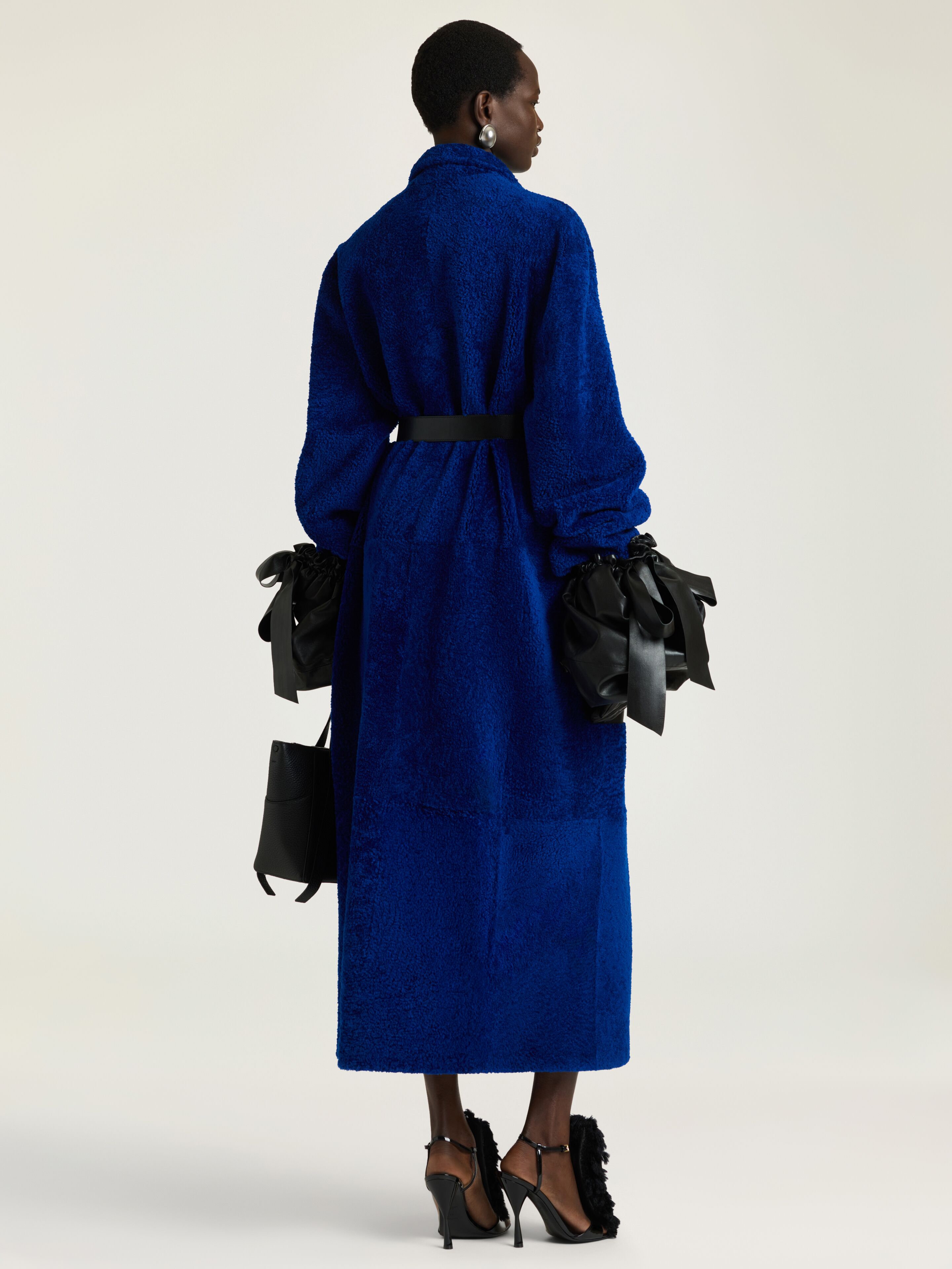 Long coat in shearling with leather pockets | Givenchy US | Givenchy