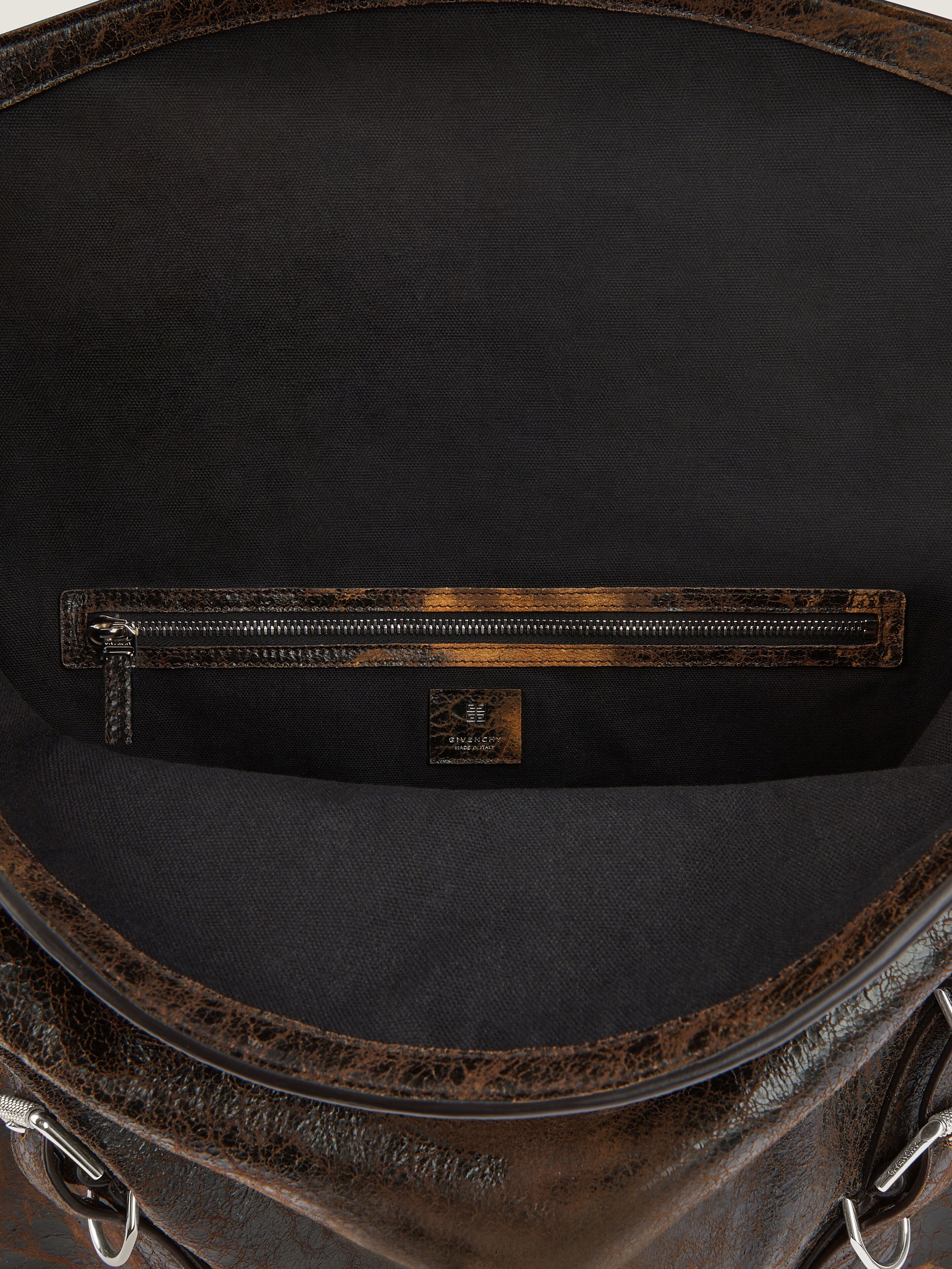Large Voyou bag in crackled leather in - black/brown mud